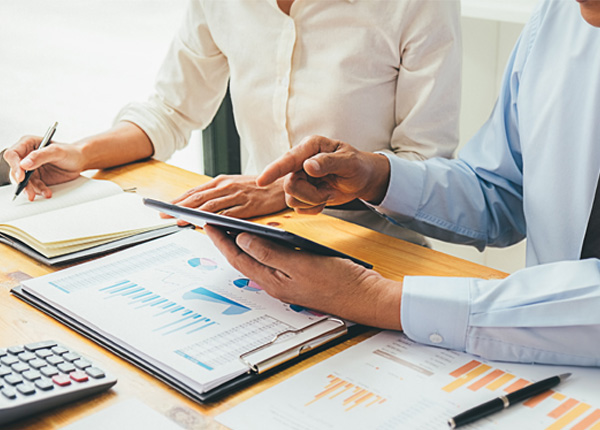 HR consultants reviewing business data and workforce reports to provide tailored HR solutions and compliance support.